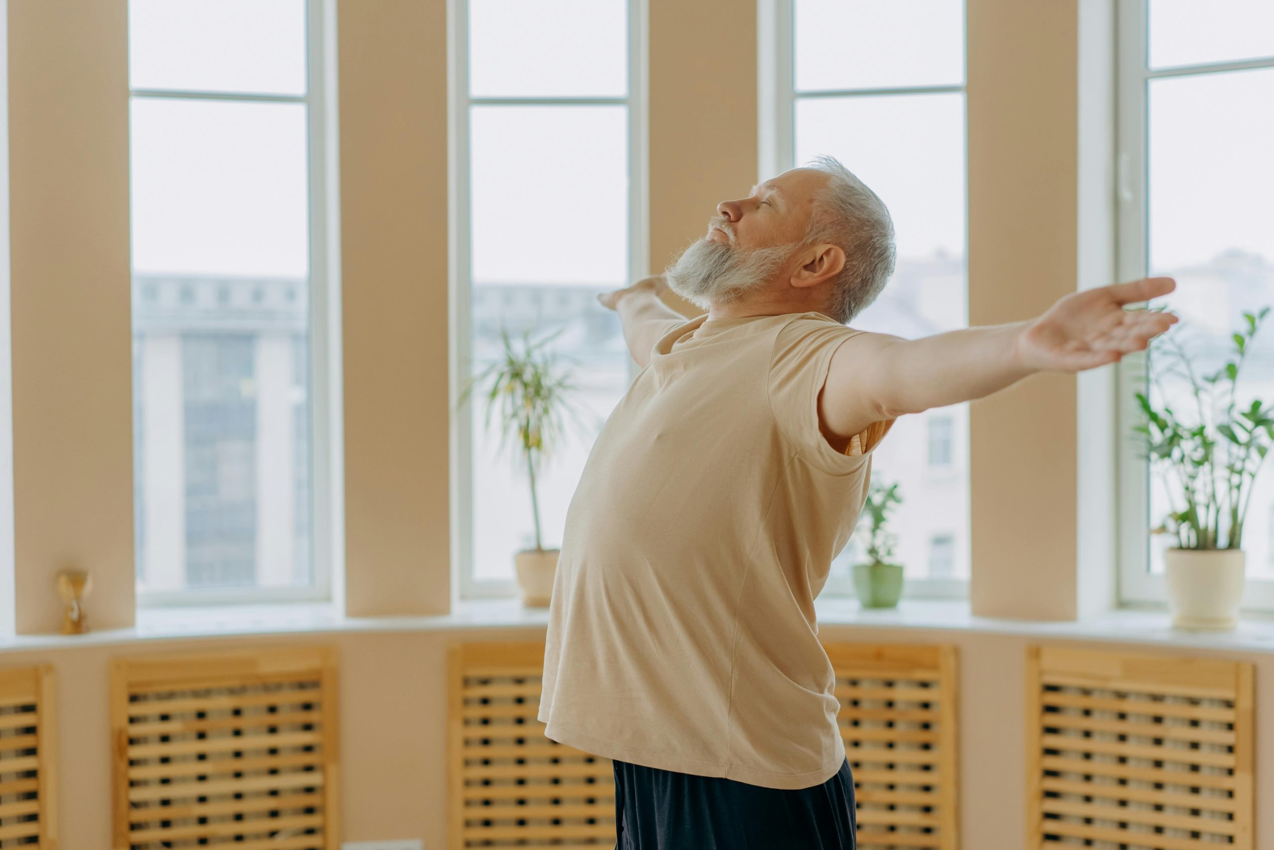 Man doing yoga inside open arms and open heart pose