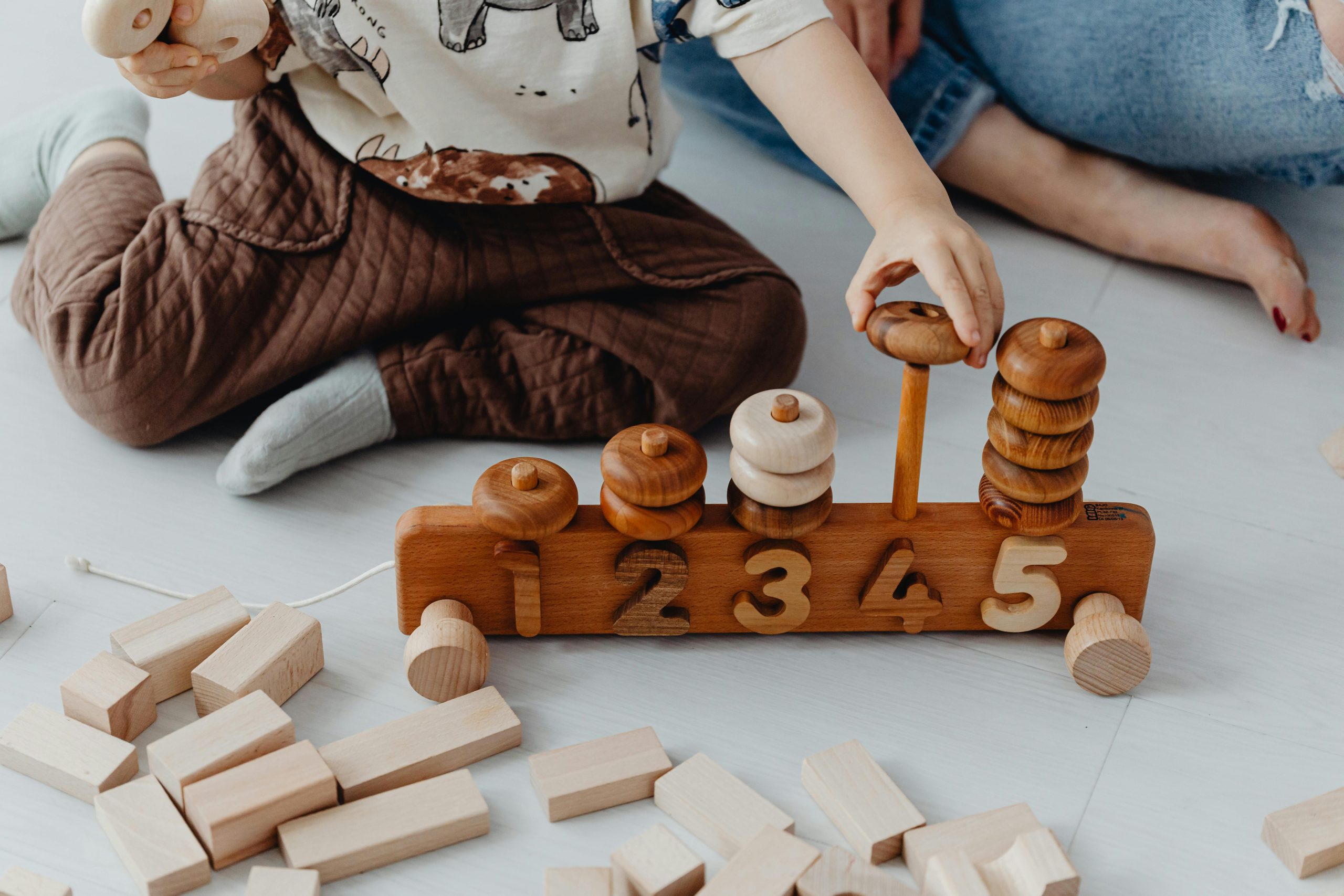 Baby plays with wooden toys stacking hoops